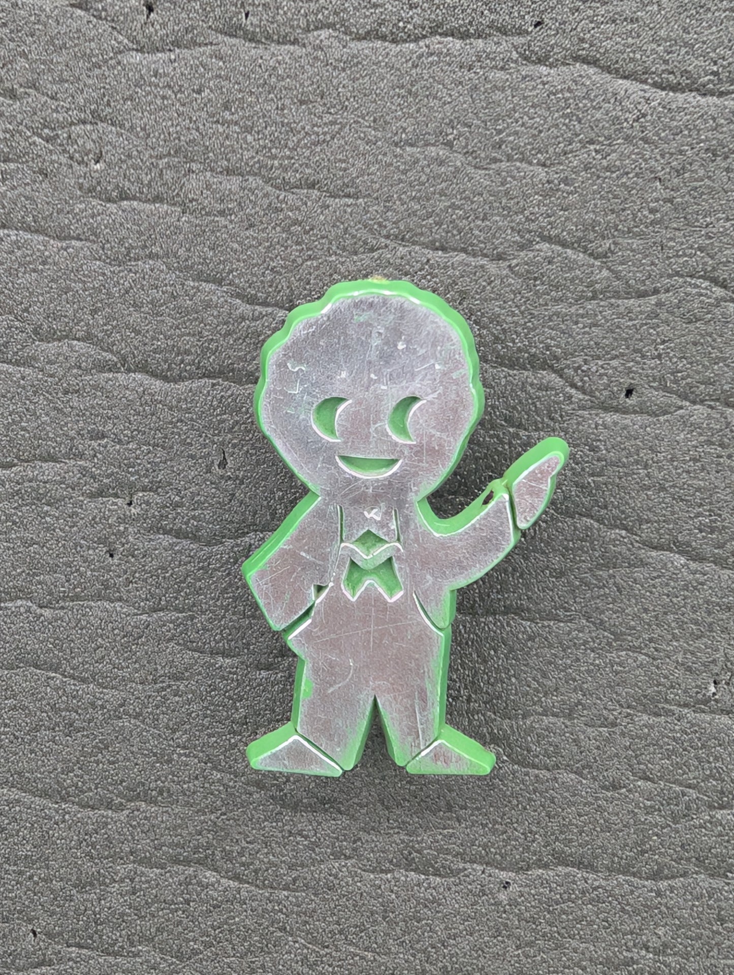 PG Plastic Golly Silver on Green 1970s