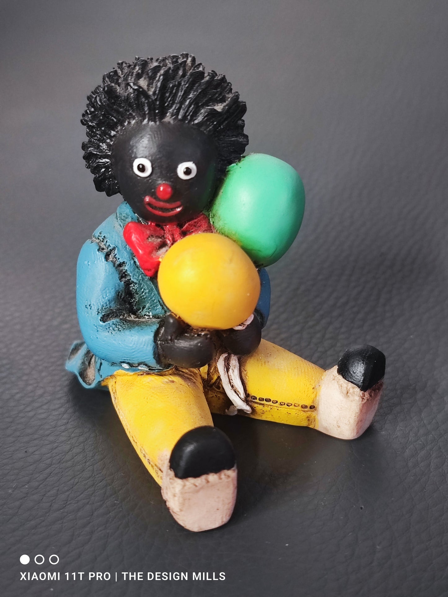 Shudehill Figure Sitting Holding Balloons